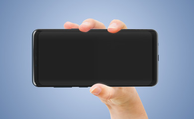 Woman hand holding smartphone mockup isolated on blue
