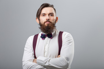 Fototapeta premium People, style and fashion concept - Portrait of bearded man dressed in white shirt over grey background