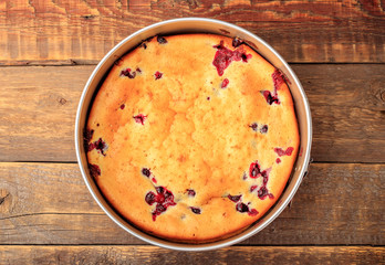 Berry pie, stuffed black currants on a wooden table. Top view