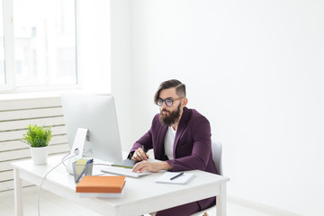 Fototapeta premium People and technology concept - Attractive man with beard, dressed in purple jacket working on at the computer