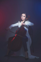 Beautiful woman in a white coat plays the cello © Антон Фрунзе
