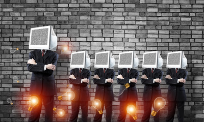 Businessmen with monitors instead of head.