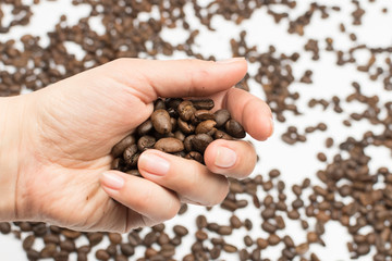 Coffee beans lie in the palm of your hand