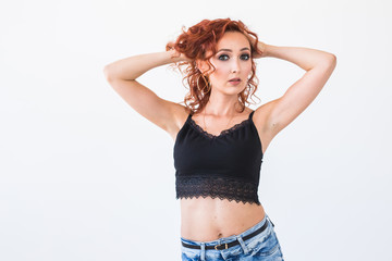 Fototapeta premium Fashion, modeling, people concept - young woman with naked belly over the white background