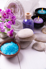 composition of the spa treatment. Candles in bowls with water, bath salts, and orchid flowers.