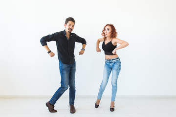Fototapeta premium Social dance concept - Crazy dancing, cheerful couple over white background