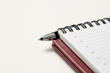 Notepad, pen on a white background.