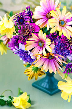 Beautiful bouquet of spring flowers in a vase on the table. Lovely bunch of flowers .Many beautiful fresh flowers on a table.