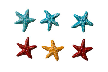 Fototapeta na wymiar Handmade ceramic decorations representing colored sea stars on the white isolated background.