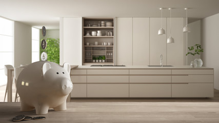Wooden table top or shelf with white piggy bank with coins, modern white and wooden kitchen, expensive home interior design, renovation restructuring concept architecture