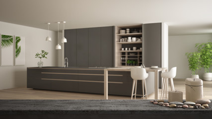 Wooden vintage table top or shelf with candles and pebbles, zen mood, over modern gray and wooden kitchen with island and stools, parquet floor, white architecture interior design