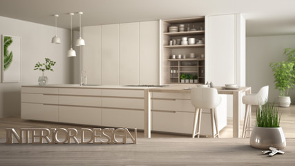 Wooden table, desk or shelf with potted grass plant, house keys and 3D letters making the words interior design, over blurred modern kitchen, project concept copy space background