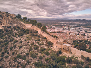 Fototapeta na wymiar Aerial view of the castle of Xativa with the town in the background on a day with blue sky and clouds
