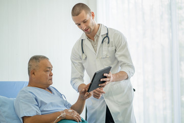 Doctor checking recovery of patient after surgery.