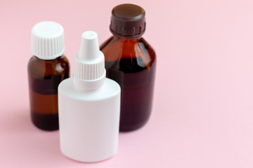 clear medicine bottles isolated at pink background. set of medicine drugs.