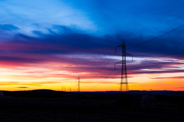 Fototapeta na wymiar silhouetted high voltage tower at sundown