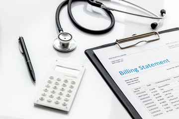 medical treatment bill, calculator and phonendoscope on white background