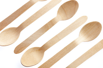 Eco-friendly materials. Wooden, disposable spoon on a white background.