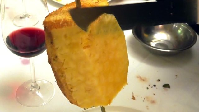 Hot and sweet cinnamon pineapple slices with sword on set table in Brazilian churrascaria steak house.