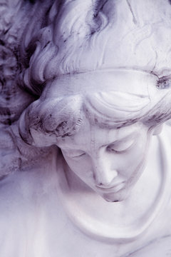 Vintage image of a sad angel. Retro stylized antique statue. Faith, religion, Christianity, death, immortality concept