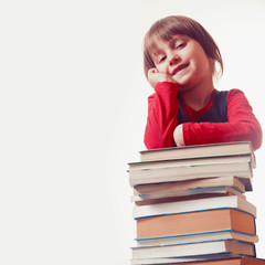 Little cute child girl on the stack of books. Education, studies and self development concept.