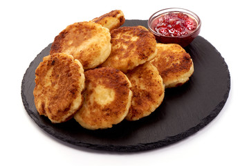 Homemade Cottage cheese pancakes with jam, close-up, isolated on white background