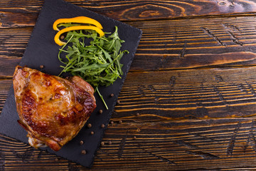 Thigh turkey baked in the oven with spices on black stone board. Healthy food. Thanksgiving dinner.