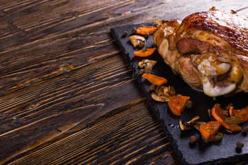Thigh turkey baked in the oven with spices on black stone board. Healthy food. Thanksgiving dinner.