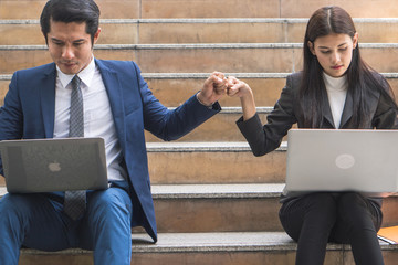 Asian colleagues team success concepts, Businessman and businesswoman looking at each other and doing fist bump celebrate after work done complete.