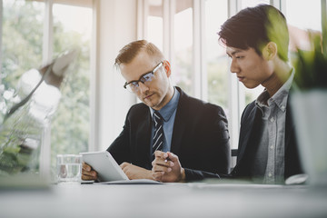 Two business people discussing work in the office in meeting.