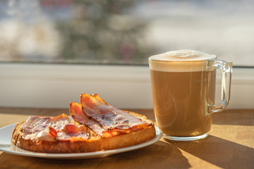 morning sun breakfast cappucino coffe sandwich bacon.