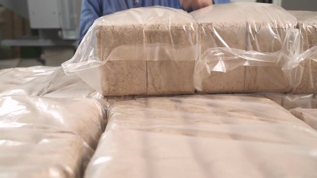 A close-up of the lumps of packed sawdust briquettes
