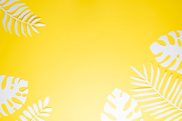 Tropical leaf pattern. Various paper leaves on a pastel background. art. Flat lay, top view. Background on yellow background. Lent background, summer mood