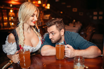Surprised drunk man stairs at breasts of waitress