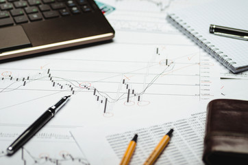 Financial charts on paper, analysis and calculations