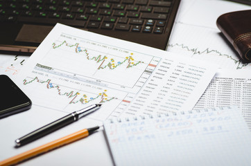Naklejka na ściany i meble Financial charts of currencies on paper, profit analysis, financier's workplace