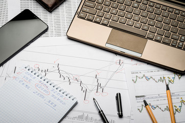 Financial charts of currencies on paper, profit analysis, financier's workplace