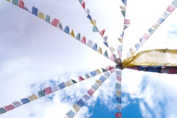 Colorful Mantra flags with blue sky as a background.Copy space