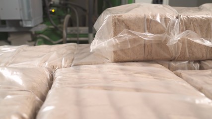 A close-up of the lumps of packed sawdust briquettes