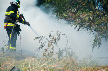 Firefighter extinguishes a fire