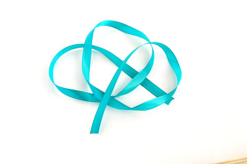 Turquoise ribbon isolated on white background. Spiral of satin ribbons. Festive decor on a white background.