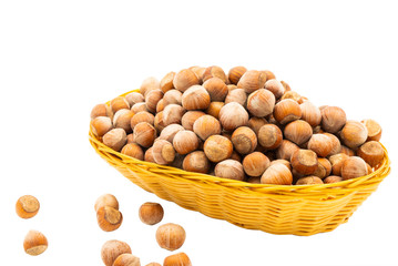 Hazelnuts in a wicker basket. Isolate on white background.