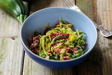 Courgette spaghetti with sun dried tomatoes and mince hazelnuts