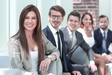 business woman and business team sitting in office