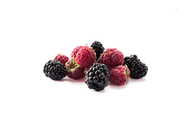 Ripe raspberries and blackberries isolated on white background. Background of mix fruits on white background. Mix berries with copy space for text.  Various fresh summer. Black and red berry on white.