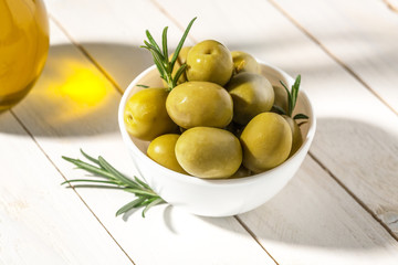Bowl with canned olives on white background