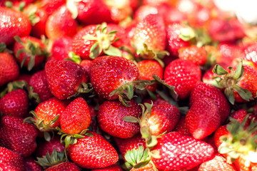 Fresh red strawberries background for sale at marketplace.