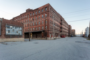 Large multiple story vintage red brick industrial warehouse ready for development in a depressed urban area - 258790791