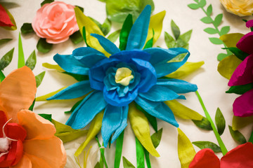 Fototapeta na wymiar Artificial paper flowers. Flowers close up. Macro photography of flowers. Origami. Homemade hobby to create jewelry. Florist creates his flowers.