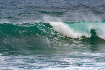 Fototapeta na wymiar close up from a crashing waves on the sea